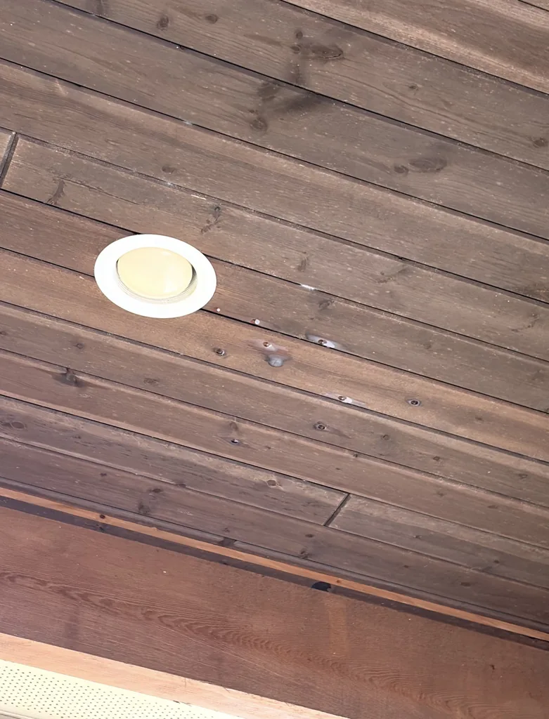 Water-stained wood porch ceiling from roof leaks before replacement, Fair Oaks Ranch TX 78015