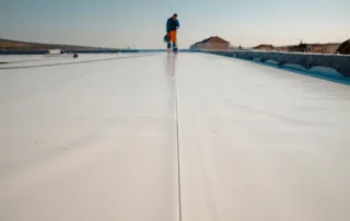 Roofer working on top of a TPO commercial roof