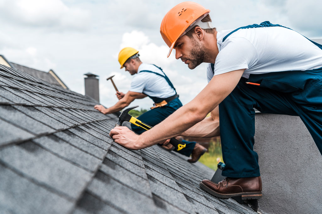 Image of professional roofing contractors installing a shingle roof