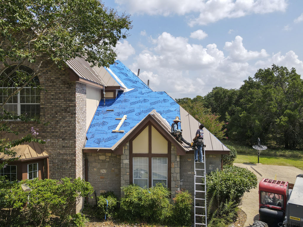 Image of Kresta Roofing installing a buckskin standing seam metal roof