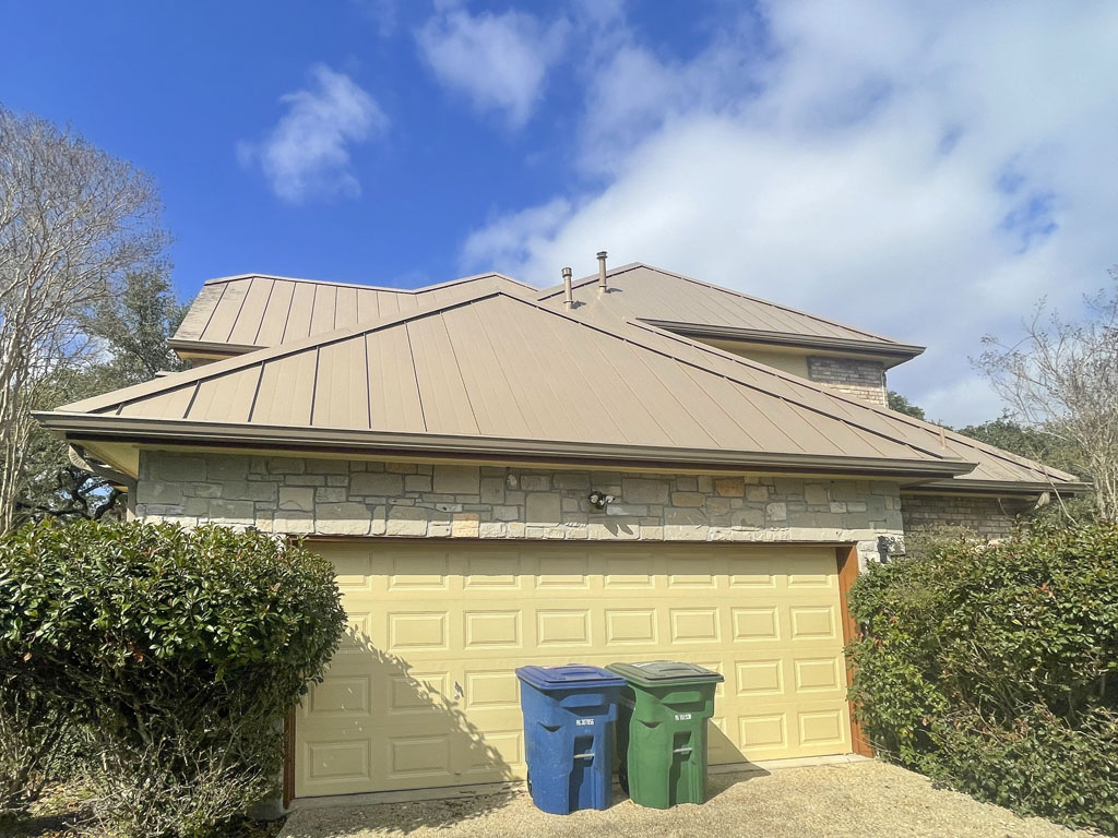 Exterior image of a residential home that had a buckskin standing seam metal roof replacement