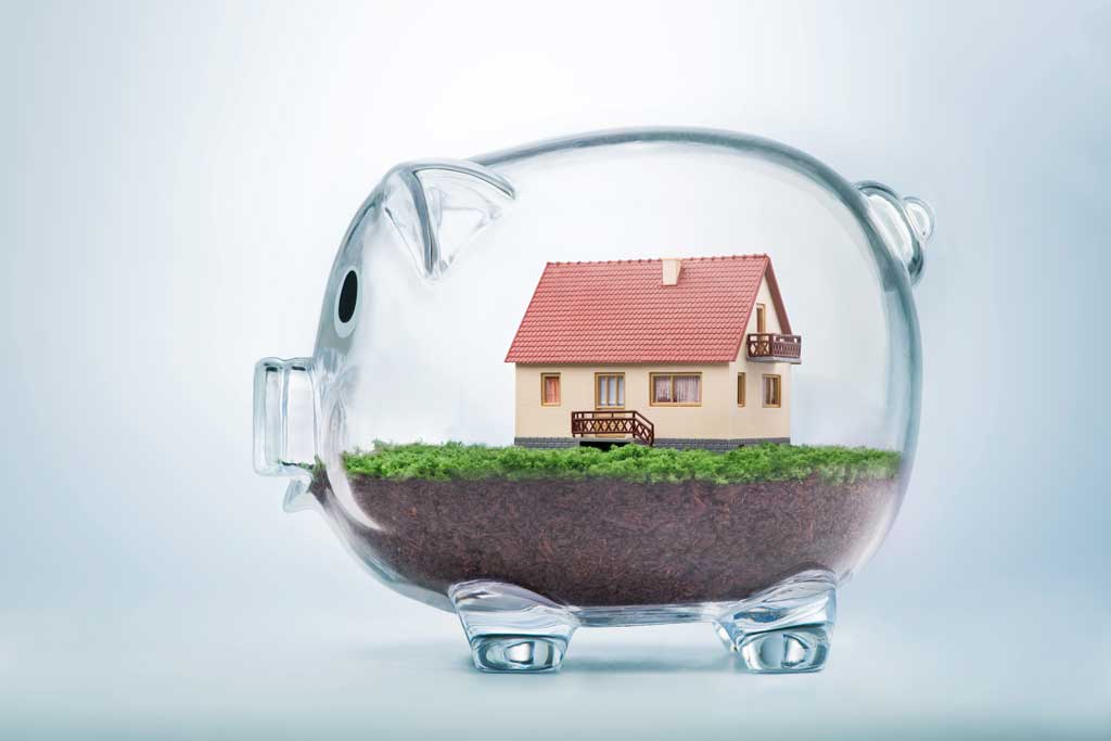 Image of a clear glass piggy bank with a house inside of it