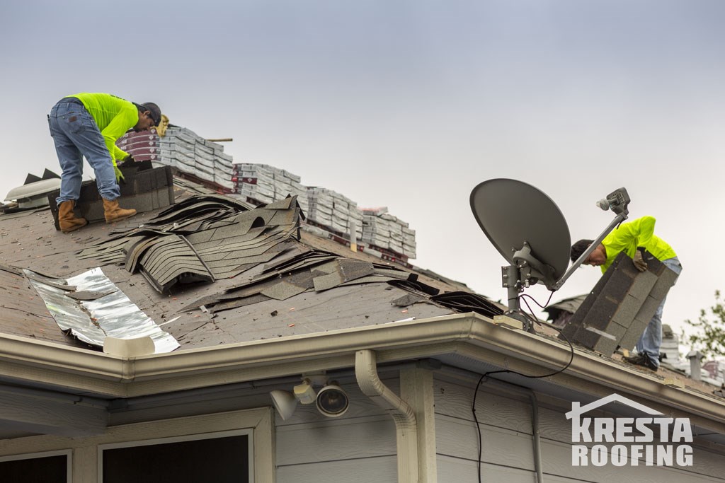 Roofing crew removing ashphalt shingles near Converse, TX